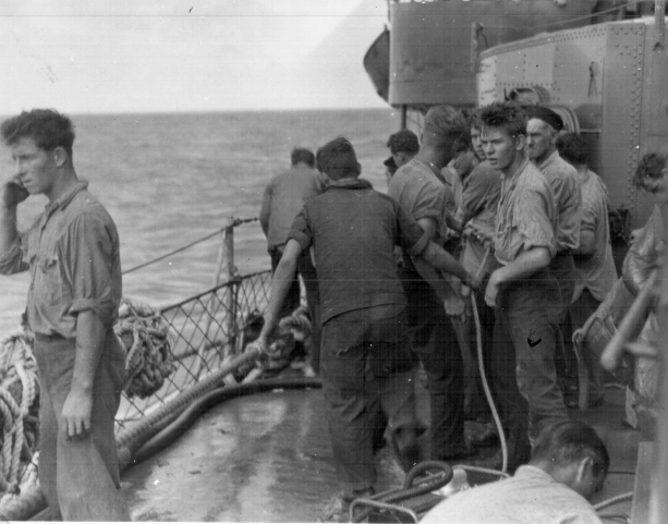 Aircraft carrier  Cowpens  collision.<br>Work party cleaning up, 18OCT1943.