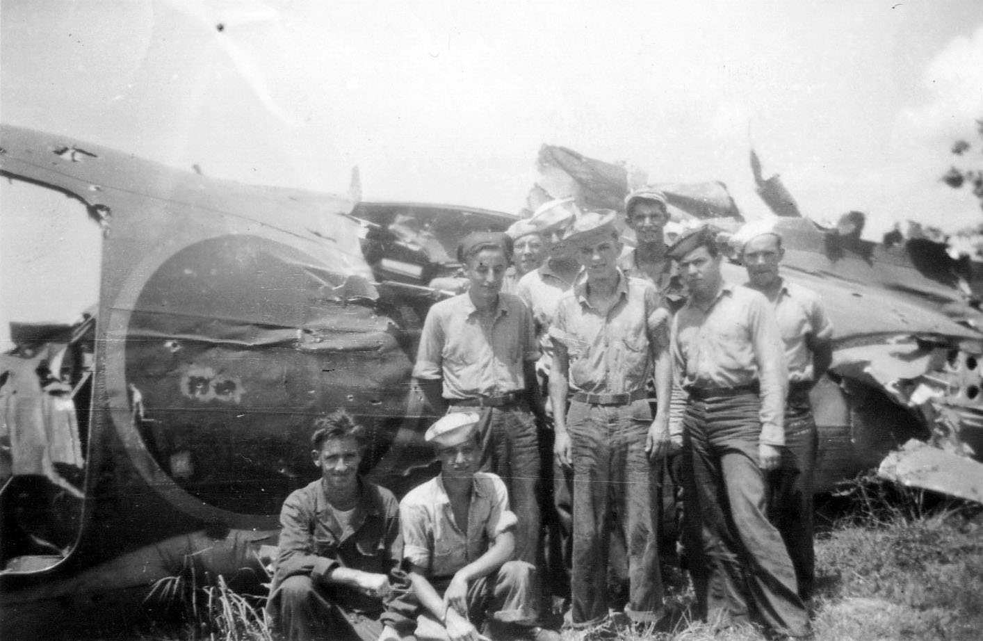 Destroyed Japanese Mitsubishi G4M-1 “Betty” bomber.<br>Standing rear: C. Angevine, [unknown], [unknown], P Withers.<br>Standing front: W. Biers, [unknown], C. Brannon.<br>Sitting: [unknown], [unknown].
